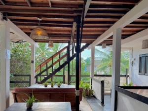 a porch with a wooden ceiling and a table at Casa OMI in Brisas de Zicatela