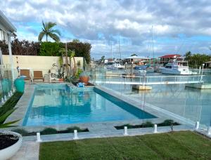 a swimming pool in a yard with a marina at Sandpiper Studio in Scarborough