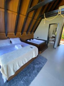 a bedroom with a bed and a bath tub at Refúgio do Morro - Cabana 1 in Torres