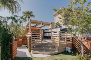 a house with a deck and a rv at Glamping Trailer Lanikai in Awaji