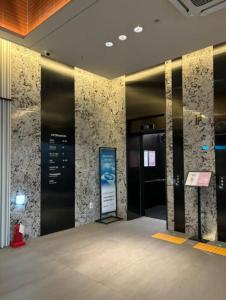 an elevator in a building with a sign on the wall at Ocean View Hotel near Incheon Airport in Chagyak-to +40 photos