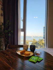 a table with a plate of food on a table with a window at Ocean View Hotel near Incheon Airport in Chagyak-to