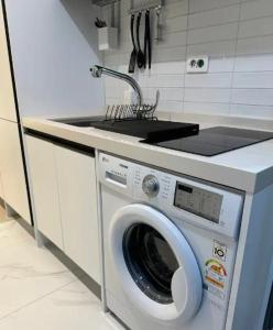 a washing machine in a kitchen with a sink at Ocean View Hotel near Incheon Airport in Chagyak-to