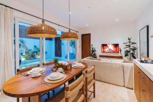 a kitchen and living room with a wooden dining room table at Villa Arlo Canggu in Canggu