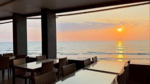 a restaurant with a view of the ocean at sunset at Du Talay Hotel Koh Chang in Ko Chang