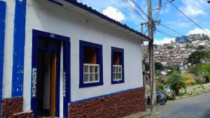 a blue and white building with blue windows at Pouso History in Ouro Preto +13 photos