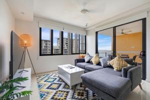 a living room with two couches and a table at Darwin Waterfront Short Stay Apartments in Darwin