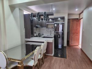 a kitchen with a table and chairs and a refrigerator at Marito in Juliaca