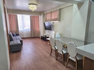 a conference room with a table and chairs and a couch at Marito in Juliaca +7 photos