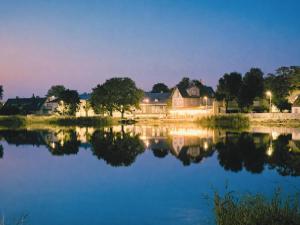 a house reflecting in the water at night at Romantic Old Town Hideaway in Haapsalu