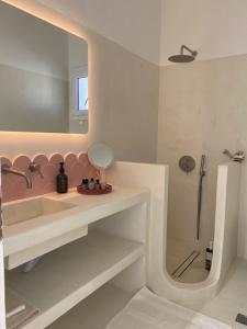 a bathroom with a pink sink and a shower at Lobster House Antiparos in Antiparos