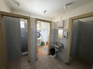 a bathroom with a shower and a sink at Coffs Harbour Hotel in Coffs Harbour +13 photos