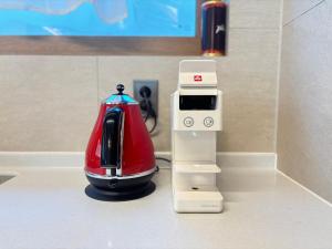 a coffee maker sitting on a counter next to a tea kettle at Hanok Hyeyum in Jeonju