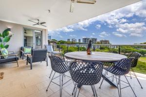 a patio with a table and chairs on a balcony at Darwin Waterfront Short Stay Apartments in Darwin