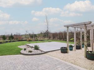 a patio with a gazebo in a park at The Loft - 96B in Articlave +9 photos