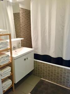 a bathroom with a sink and a shower curtain at Dream Apartments in Serris