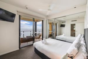 a hotel room with two beds and a balcony at Darwin Waterfront Short Stay Apartments in Darwin +247 photos