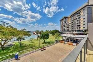 an apartment balcony with a view of a park at Darwin Waterfront Short Stay Apartments in Darwin