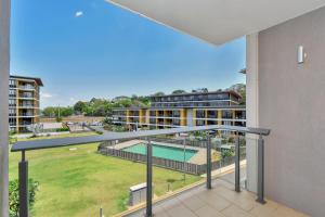an apartment balcony with a view of a pool at Darwin Waterfront Short Stay Apartments in Darwin