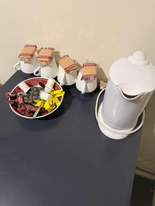 a table with four pots and a bowl of food at Coffs Harbour Hotel in Coffs Harbour