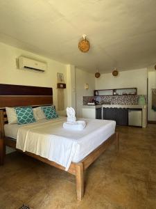 a bedroom with a large bed in a room at Malinao Beachfront Studio, Starlink, Solar in General Luna +8 photos