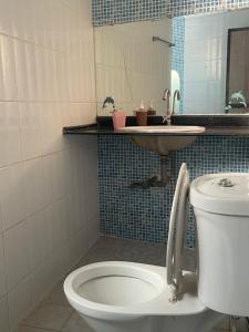 a bathroom with a toilet and a sink at Vista Maria Guesthouse in Dona Paula