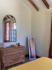 a dressing room with a dresser and a mirror at La villa Surette in Capesterre
