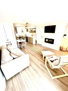 a living room with a couch and chairs and a table at Harbour Hideaway, Porthleven in Porthleven