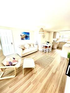 a living room with a couch and a table at Harbour Hideaway, Porthleven in Porthleven