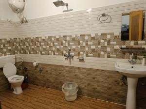 a bathroom with a toilet and a sink at Bir Nest Hostel in Bīr +22 photos