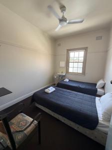 a bedroom with two beds and a window at Coffs Harbour Hotel in Coffs Harbour