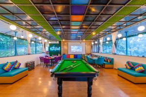 a billiard room with a pool table and couches at goSTOPS Mussoorie Clock Tower in Mussoorie