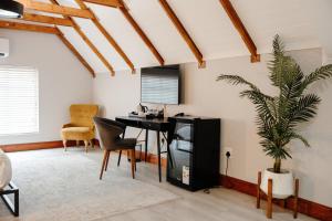 a living room with a desk and a plant at Uitsig Boutique Hotel in Welkom