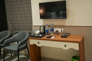 a table with two chairs and two bottles of water on it at Hotel Regency Grand in Shikrapur +33 photos