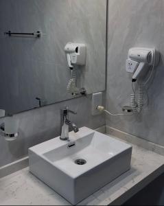 a bathroom with a white sink and a mirror at 88th Nuwara Eliya in Nuwara Eliya +27 photos