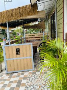 a patio with a wooden door and a bench at Olango Island - S&E-1 Tiny Guest House Fully Furnished with Hot Shower, Washer, Wi-Fi, Netflix & King-size Bed in Lapu Lapu City