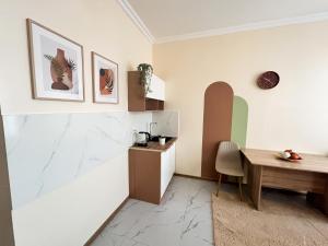 a kitchen and dining room with a wooden table at Bekarys Hotel in Astana +20 photos