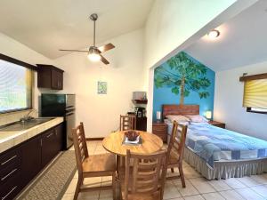 a kitchen and a bedroom with a bed and a table at Calm & Palms Second Floor Studio in Coco +29 photos