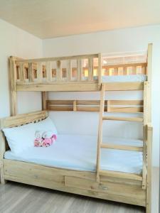a bunk bed with two teddy bears sitting on it at Rustic Retreat Three Bedroom House in Pagdalagan