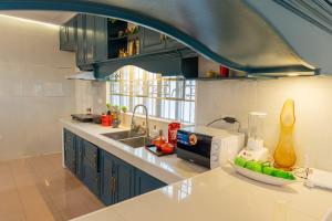 a kitchen with a sink and a counter top at White House, Billiard, Private Pool, Prime Location in Angeles