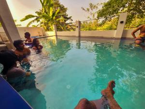 a group of people in a swimming pool at Villa SOORYAALI in Galle +8 photos