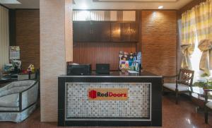 a red door sign on a tv in a lobby at RedDoorz Plus at Canley Residential in Manila