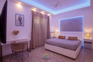a bedroom with a bed and a table and a chair at Coho House Fiumicino in Fiumicino