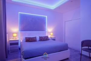 a bedroom with a bed with two tables and two lamps at Coho House Fiumicino in Fiumicino