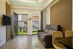 a living room with a couch and a table at Coho House Fiumicino in Fiumicino