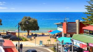 a view of a beach from a street with buildings at Oceans Edge #7 Accom Holidays in Terrigal