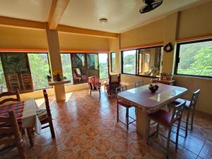 a dining room with a table and chairs and windows at Casa Blanca Zipolite, Dream House in Zipolite