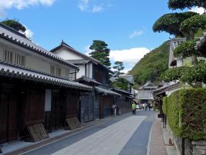 an empty street in an asian town with buildings at Hotel Yassa in Mihara
