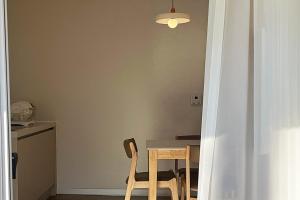 a table and chairs in a kitchen with a light at Jeonju One Two Stay in Jeonju