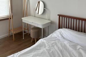a bedroom with a dressing table and a bed at Jeonju One Two Stay in Jeonju +6 photos